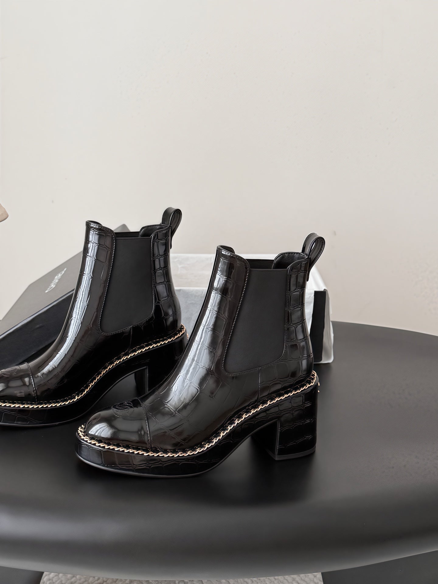 CHANEL 26S CHELSEA ANKLE BOOTS 70 MM IN BLACK EMBOSSED AND PATENT