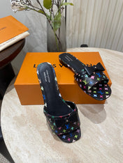 BOW FLAT MULES IN BLACK MONOGRAM LAMBSKIN