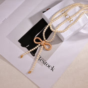CD 26S PEARL BOW DROP STATEMENT NECKLACE IN GOLD TONE METAL 629848