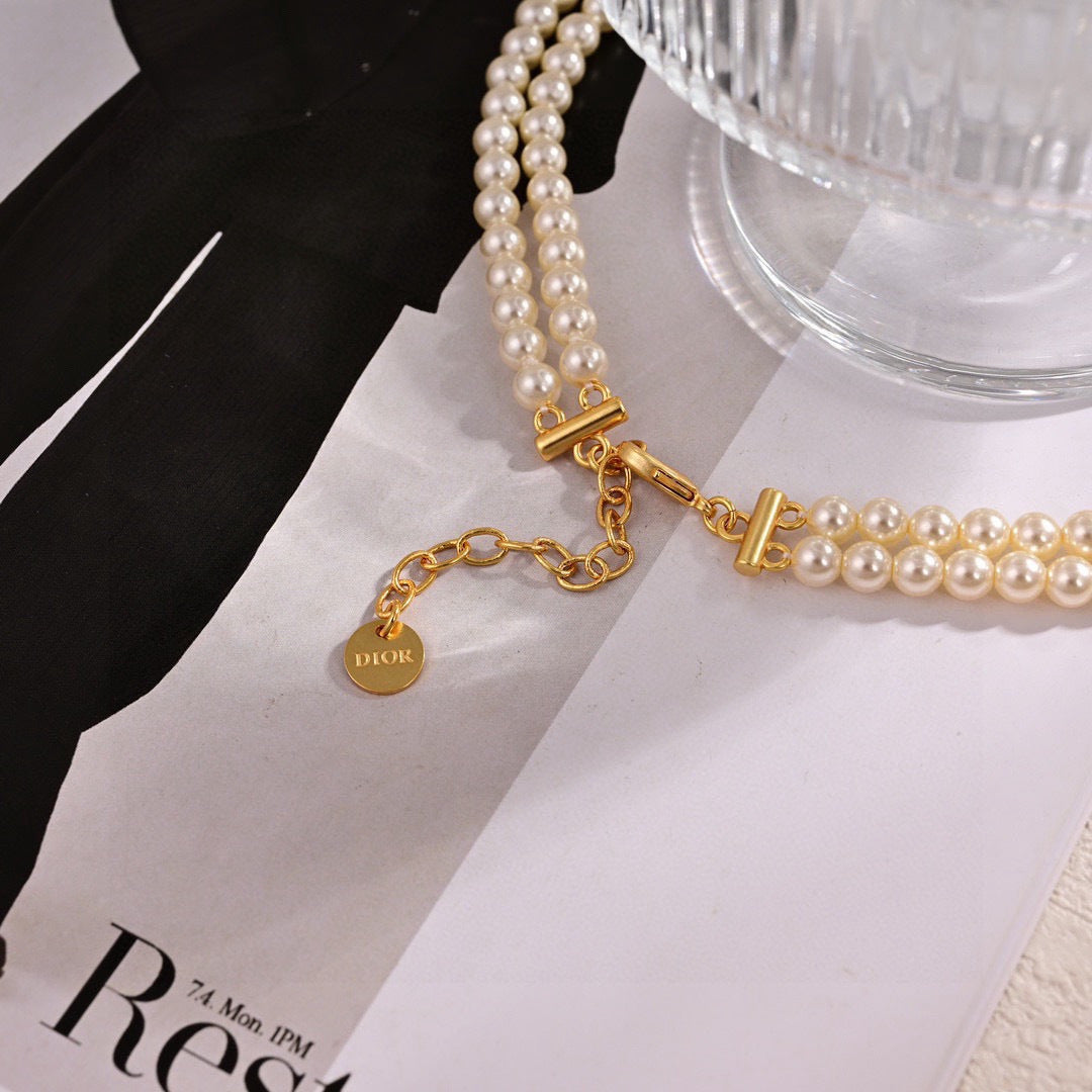CD 26S PEARL BOW DROP STATEMENT NECKLACE IN GOLD TONE METAL 629848
