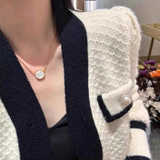MIUMIU 26S ROUND LOGO PENDANT NECKLACE IN WHITE ENAMEL AND GOLD TONE METAL 630864