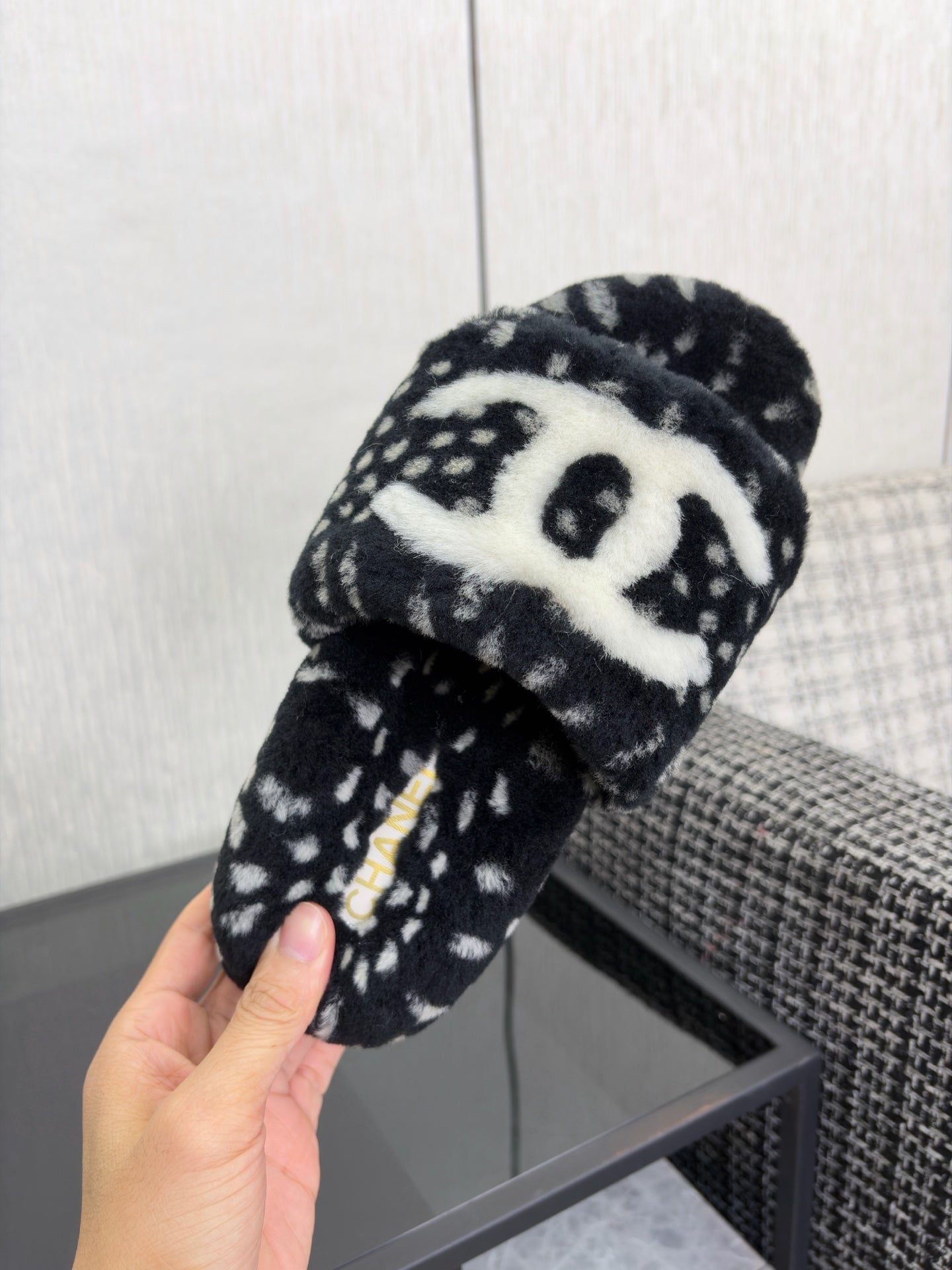 CHANEL 26S PLATFORM SLIDE SANDALS IN BLACK SHEARLING AND WHITE LOGO GG DALMATIAN PRINT