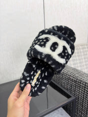 CHANEL 26S PLATFORM SLIDE SANDALS IN BLACK SHEARLING AND WHITE LOGO GG DALMATIAN PRINT