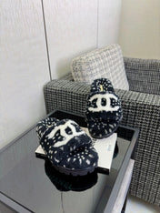 CHANEL 26S PLATFORM SLIDE SANDALS IN BLACK SHEARLING AND WHITE LOGO GG DALMATIAN PRINT