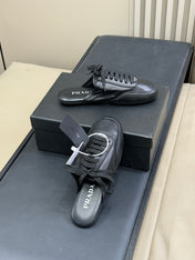 PRADA 25S COLLAPSE MULES IN BLACK CALFSKIN