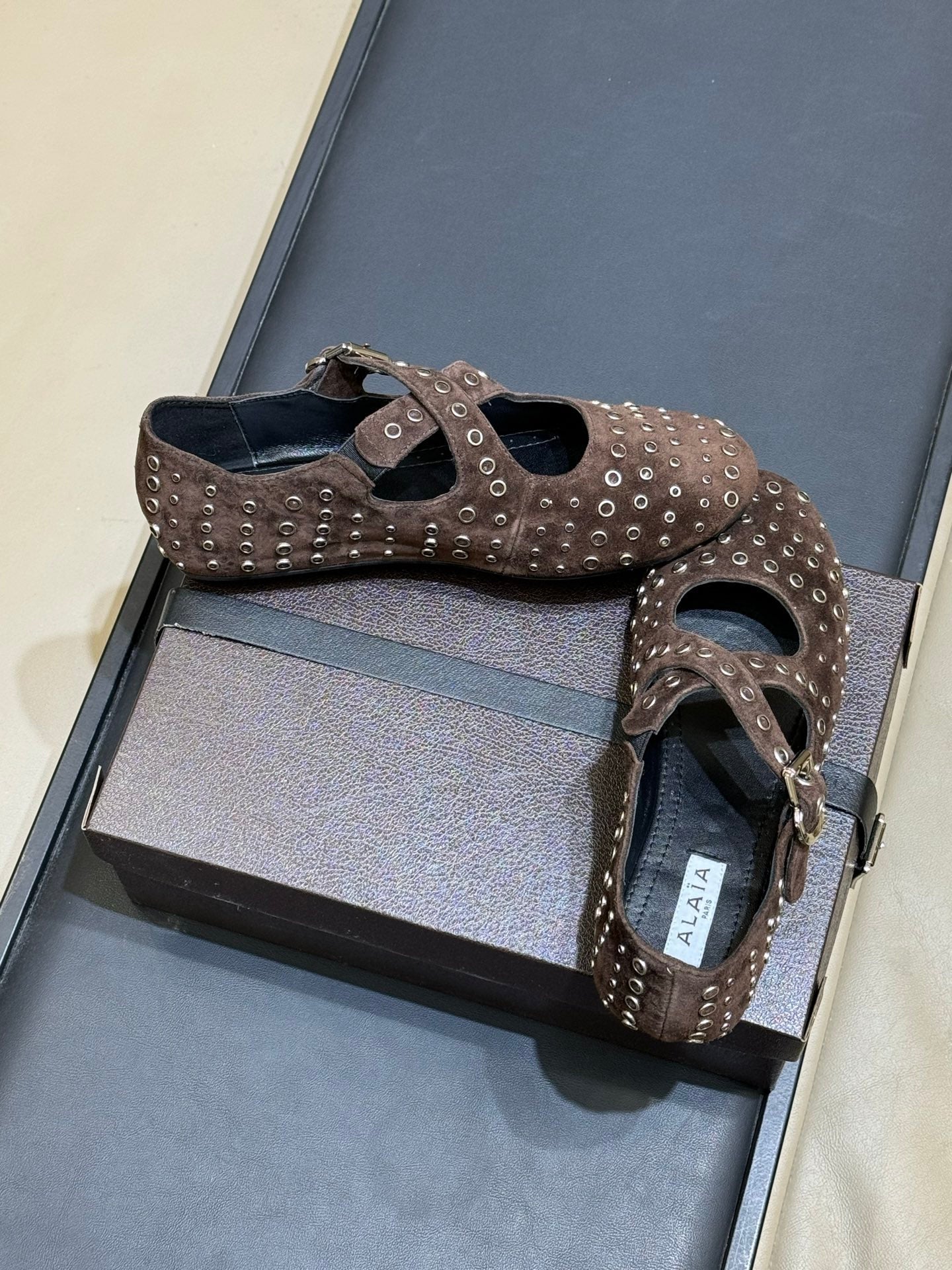 ALAIA 26S CROSS-STRAP FLATS IN DARK BROWN SUEDE WITH SILVER HARDWARE