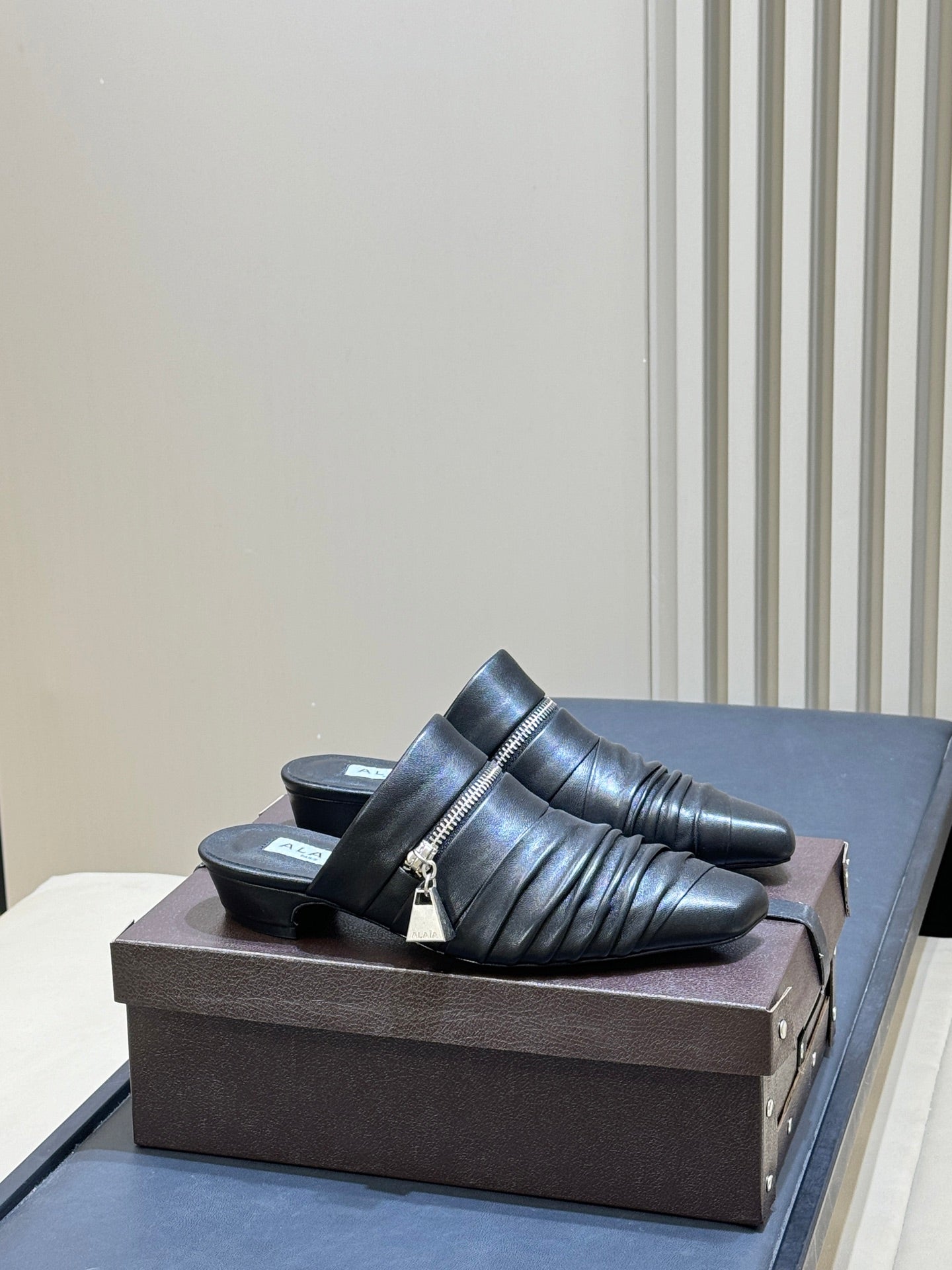 ALAIA 26S PLEATED MULES IN BLACK LAMBSKIN