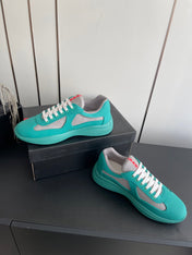 PRADA 26S AMERICA CUP SNEAKERS IN TEAL BLUE SOFT RUBBER AND BIKE FABRIC
