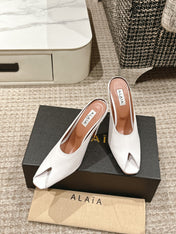ALAIA SPIKE JEWEL MULES IN WHITE CALFSKIN