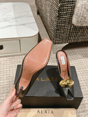 ALAIA SPIKE JEWEL MULES IN BLACK CALFSKIN WITH GOLD HARDWARE