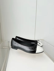 CHANEL 26S BALLET FLATS IN BLACK CRACKED CALFSKIN WITH WHITE TOE CAP AND BOW