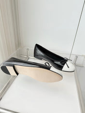 CHANEL 26S BALLET FLATS IN BLACK CRACKED CALFSKIN WITH WHITE TOE CAP AND BOW