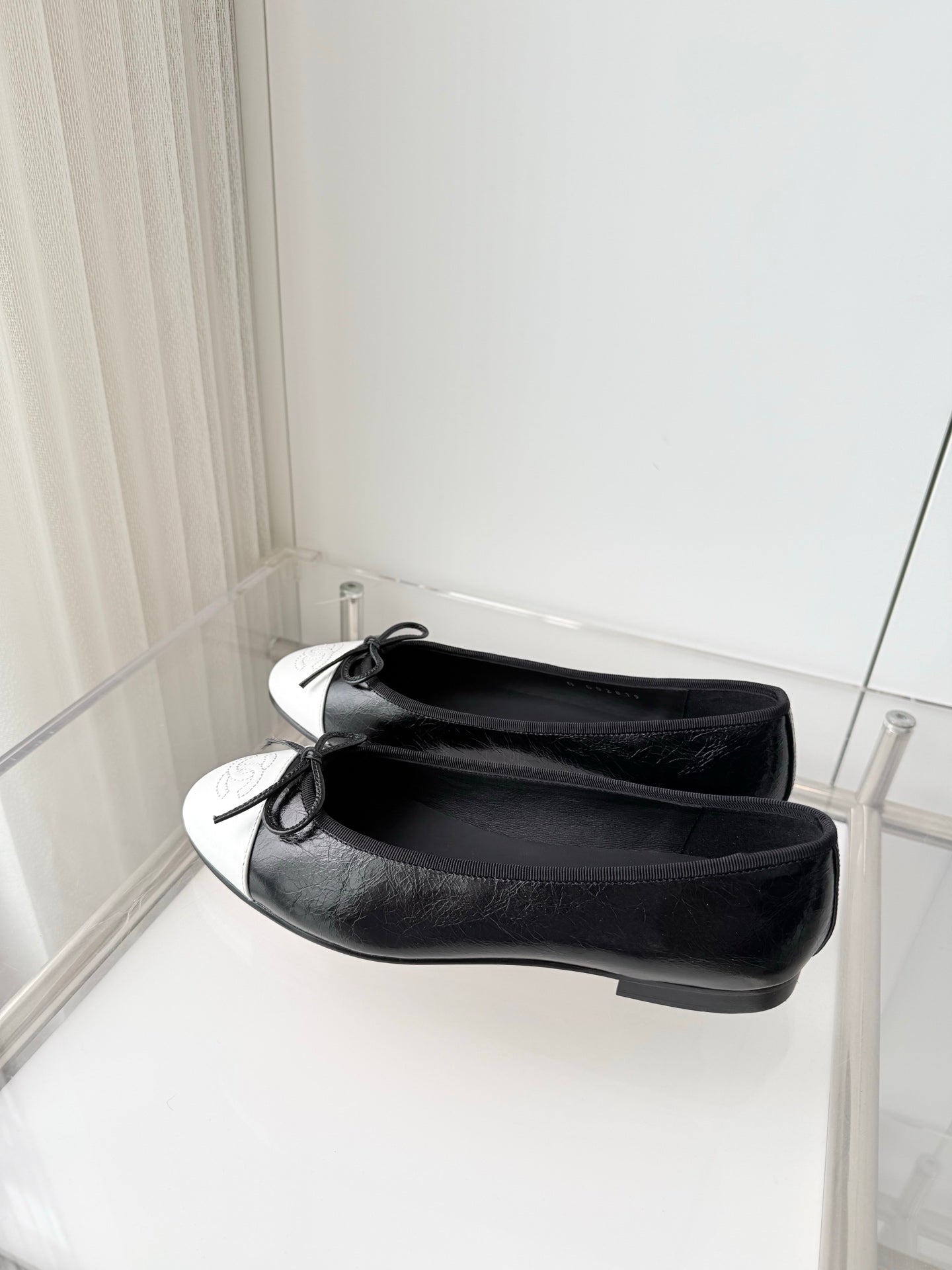 CHANEL 26S BALLET FLATS IN BLACK CRACKED CALFSKIN WITH WHITE TOE CAP AND BOW