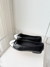 CHANEL 26S BALLET FLATS IN BLACK CRACKED CALFSKIN WITH WHITE TOE CAP AND BOW
