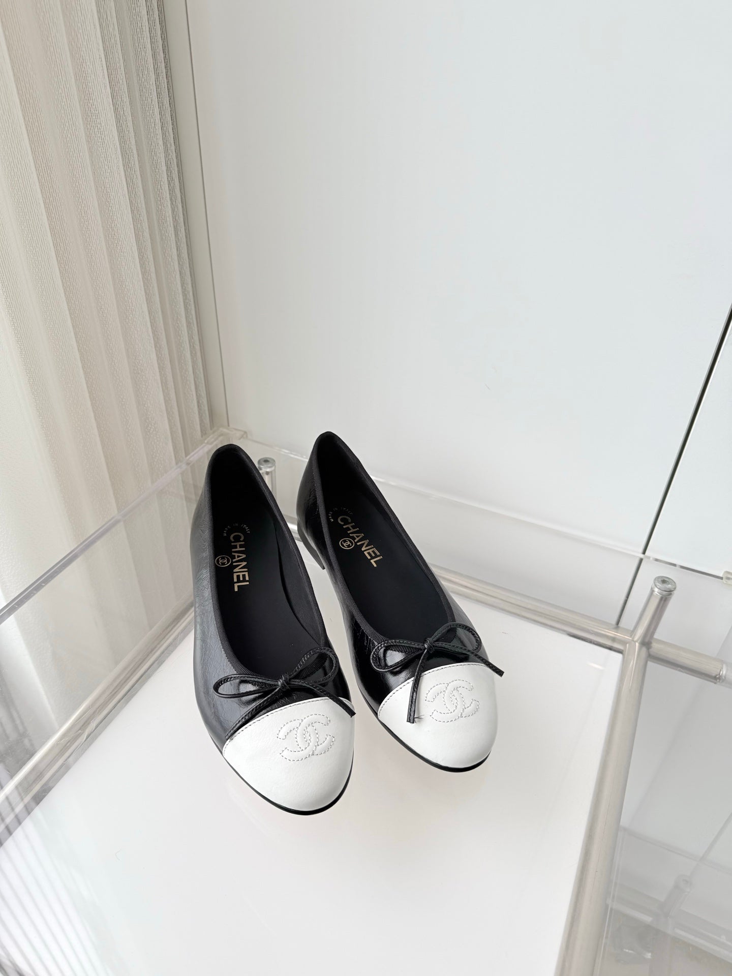 CHANEL 26S BALLET FLATS IN BLACK CRACKED CALFSKIN WITH WHITE TOE CAP AND BOW