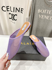 ALAIA FLAT MULES IN LIGHT PURPLE MESH FISHNET
