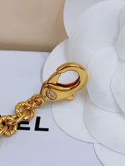 TWISTED CHAIN BELT WITH RHINESTONES AND LOGO PLATE IN GOLD TONE