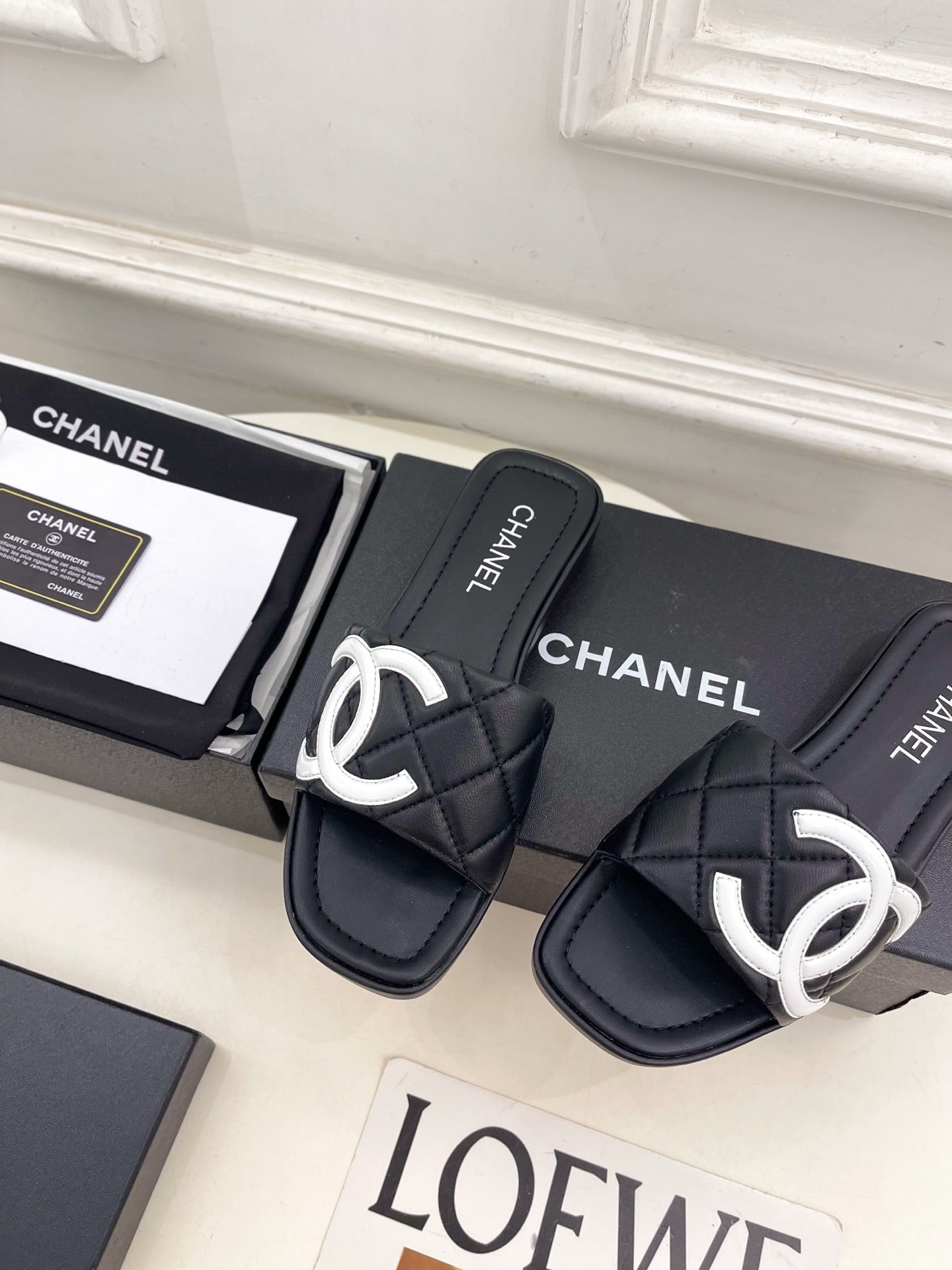CHANEL 26S FLAT SLIDES IN BLACK LAMBSKIN WITH WHITE CC LOGO