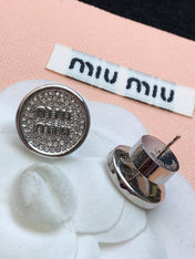 MIUMIU 26S CRYSTAL MIU LOGO ROUND STUD EARRINGS IN SILVER TONE METAL 630845